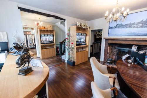 a living room filled with furniture and a fireplace at Quob Park Old House Hotel & Spa in Fareham