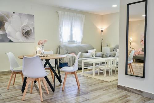 a living room with a table and chairs and a couch at Villa Canela in Illora