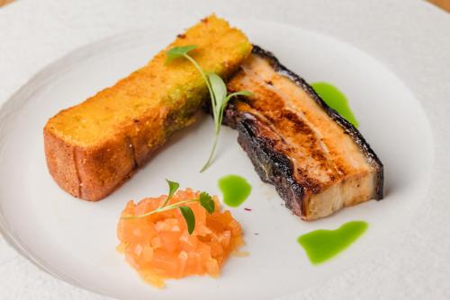 a plate of food with a piece of meat and bread at Quob Park Old House Hotel & Spa in Fareham