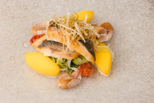 a sandwich with vegetables and cheese on a table at Quob Park Old House Hotel & Spa in Fareham