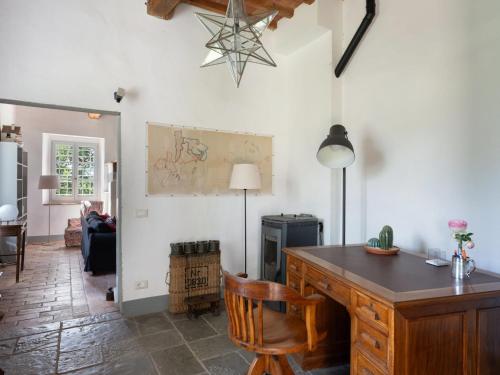 a living room with a table and a chair at Holiday Home Mirandola by Interhome in Vicchio
