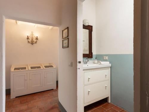 a bathroom with a sink and a vanity with a mirror at Holiday Home Mirandola by Interhome in Vicchio