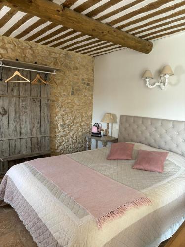 a bedroom with a large bed in a room at La petite plaine in Clansayes