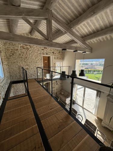 a room with a staircase in a stone building at La petite plaine in Clansayes