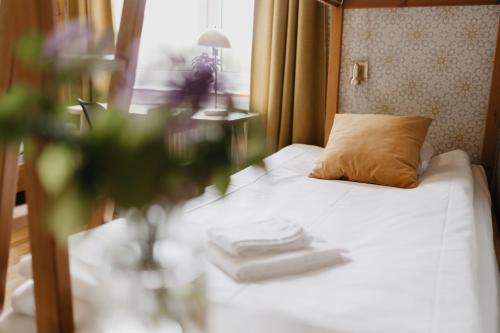 a bedroom with a bed with a pillow and a table at Vassbo Vandrarhem in Falun