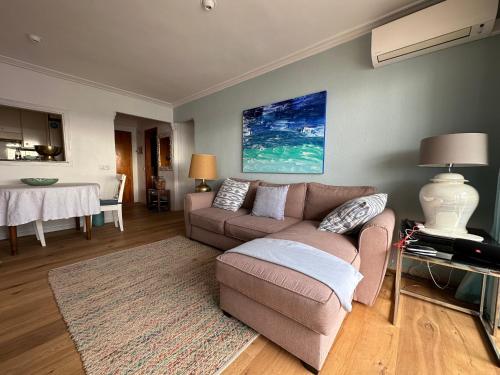 a living room with a couch and a table at Beach Apartment with Stunning View in Can Pastilla