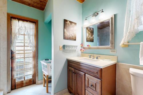 a bathroom with a sink and a mirror at Big View Hideaway in Key Largo