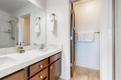 a bathroom with a sink and a mirror and a shower at Nevis at Newpark Unit 4 in Park City