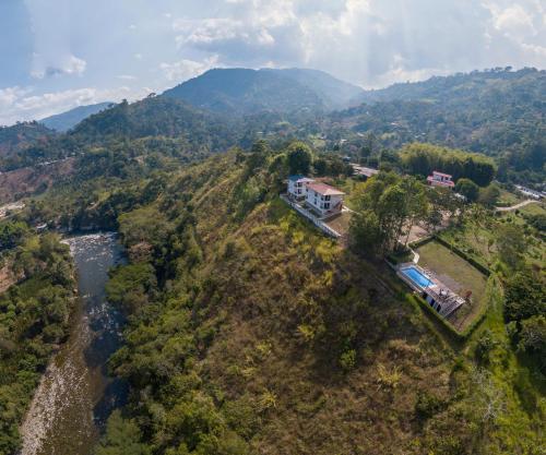 an aerial view of a house on a hill next to a river at Hotel Campestre El Triunfo in San Agustín