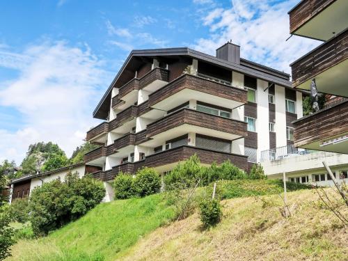 a building on top of a hill at Apartment Panorama da muntognas by Interhome in Trin