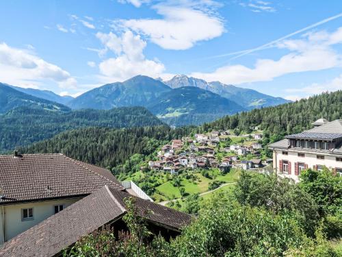a town in the mountains with houses and trees at Apartment Panorama da muntognas by Interhome in Trin