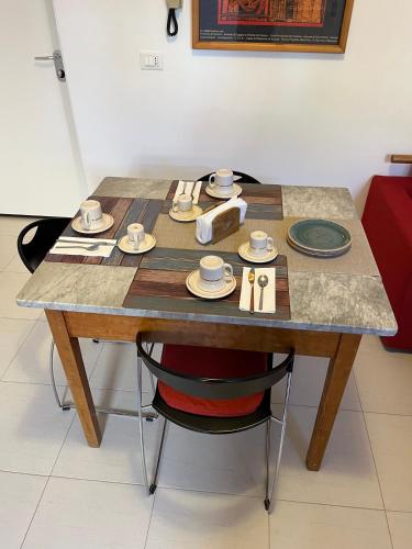 a table with plates and bowls on it at mineVaganti in Ancona