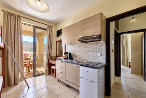 a kitchen with a sink and a counter top at Villa Gereoudis SeaView Apartments-Pool & Bar in Kolymvari
