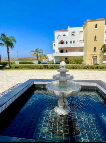 a water fountain in front of a building at Palacio de Sofia & Luxury in Asilah