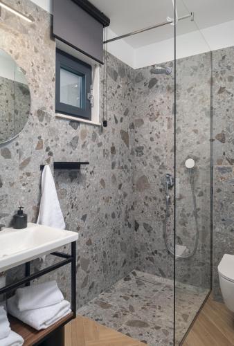 a bathroom with a glass shower and a sink at Luxury Villa David 1 - heated pool 38m2 in Podstrana