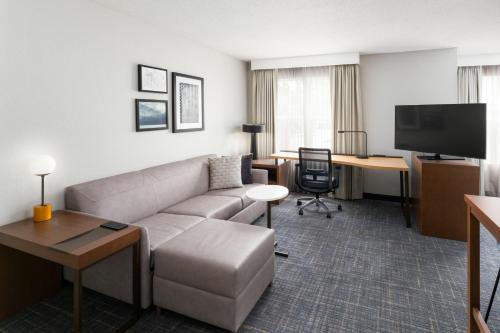 a living room with a couch and a desk at Residence Inn by Marriott Lakeland in Lakeland
