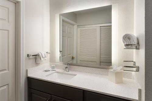 a bathroom with a sink and a mirror at Residence Inn by Marriott Lakeland in Lakeland