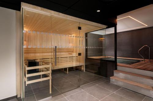 a sauna with a glass wall and a staircase at Aloft Hotel, By Marriott in Dijon