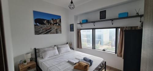 a bedroom with a bed and a large window at ΑΘΗΝΑ A7 in Katerini