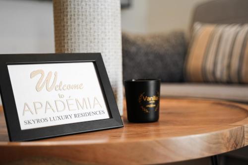 a sign on a table next to a coffee mug at Apademia Skyros Luxury Residences in Skiros