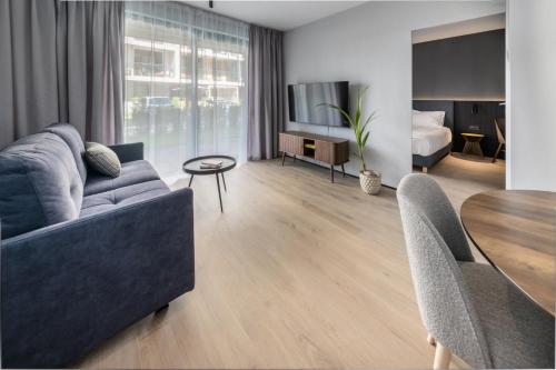 a living room with a couch and a table at Apartamenty na Półwyspie Wydma&Las in Jastarnia