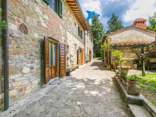 an alley in an old stone building with a door at Apartment Mangiatoia by Interhome in Greve in Chianti