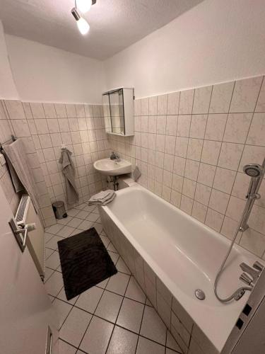 a white bathroom with a tub and a sink at Apartment Diez in Diez
