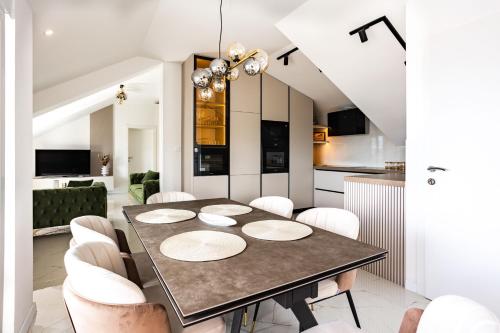 a dining room with a table and white chairs at Sea view APARTMENT PEPE in Podstrana