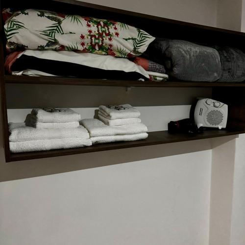 a shelf with towels and a phone on it at Santino Apart in Puerto Iguazú
