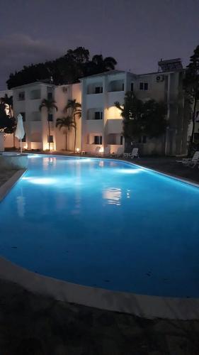 a large blue swimming pool in front of a building at Tropical Casa Laguna in Cabarete