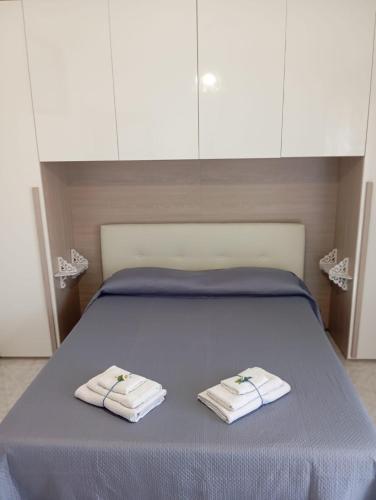 a bedroom with a bed with towels on it at Principe Umberto in Contursi Terme