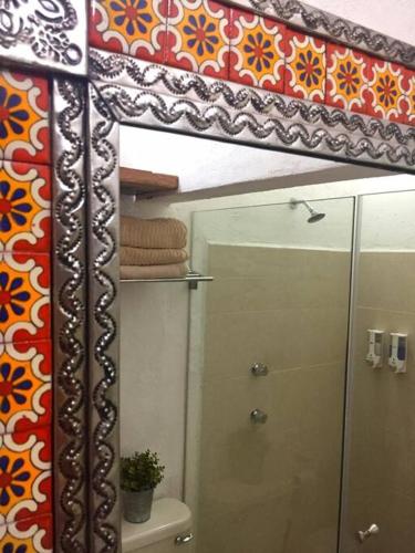 a mirror in a bathroom with a sink at Mexican Loft by LA Casa Cosme in the city center in San Luis Potosí