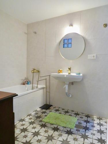 a bathroom with a sink and a tub and a mirror at El Encanto in Monachil
