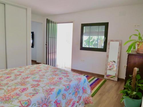 a bedroom with a bed and a window at El Encanto in Monachil