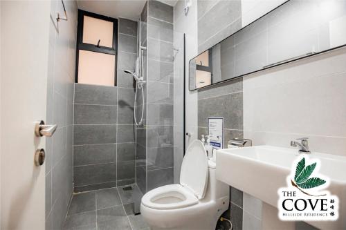 a bathroom with a toilet and a sink at Ipoh Tambun Waterpark Apartment The Cove Hillside in Ipoh