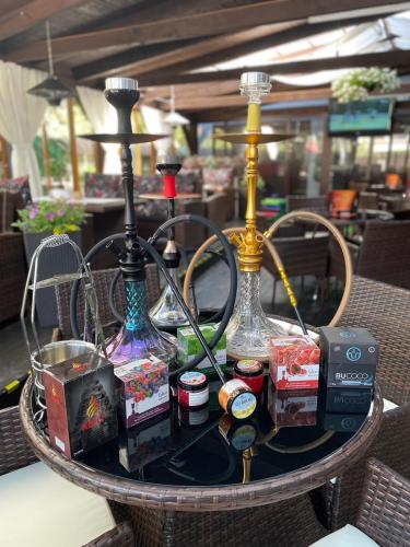 a table with three glass bottles on top of it at Penzion Panda in Turčianske Teplice