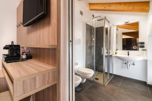 a bathroom with a shower and a toilet and a sink at Residence Al Frantoio in Arco