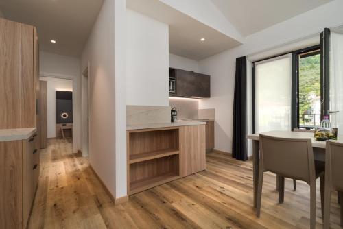a kitchen and dining room with a table and chairs at Residence Al Frantoio in Arco