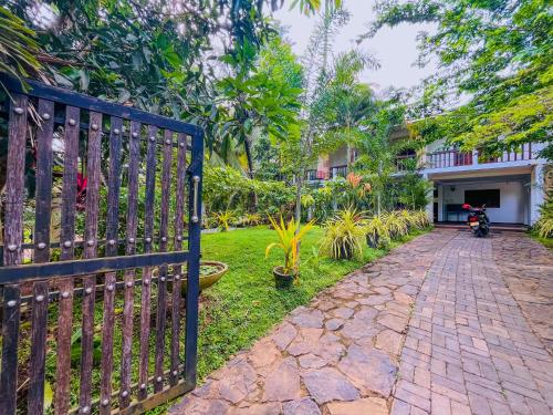 a gate leading to a house with a driveway at Lake View Villa - Tangalle in Tangalle