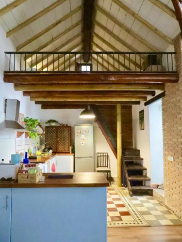 a kitchen with a loft with a staircase in it at El Encanto in Monachil