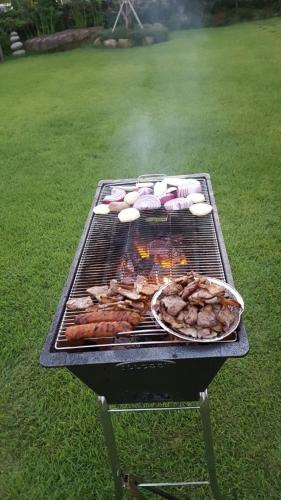 a grill with many different types of food on it at Suncheon Sagyejeol Haeoreum Hanok Pension in Suncheon