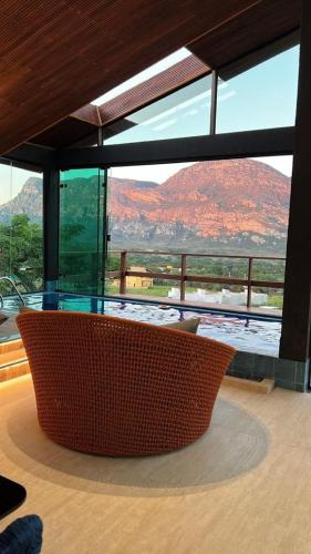 a glass table in a room with a view of a mountain at Casa 422 - Loft Bromélia in Santana do Riacho