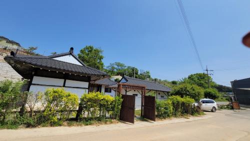 a house on the side of a street at Paju Hanokaeseo Harureul in Paju