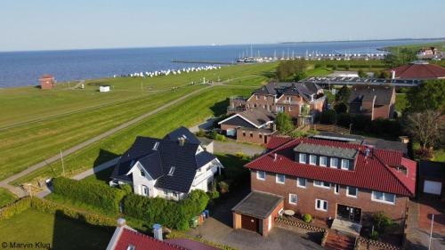 an aerial view of a house and the ocean at NordseeResort Hotel & Suite Arche Noah in Horumersiel