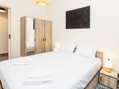 a bedroom with a white bed and a mirror at S37 Acropolis View in Athens