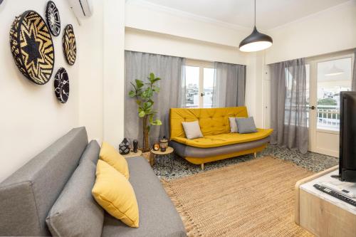 a living room with a couch and a yellow chair at S37 Acropolis View in Athens