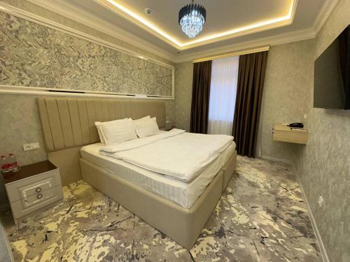 Кровать или кровати в номере Ko'k Saroy Plaza Hotel
