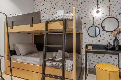 a bunk bed with a ladder next to a desk at Perth Luxury Living, Athens in Athens