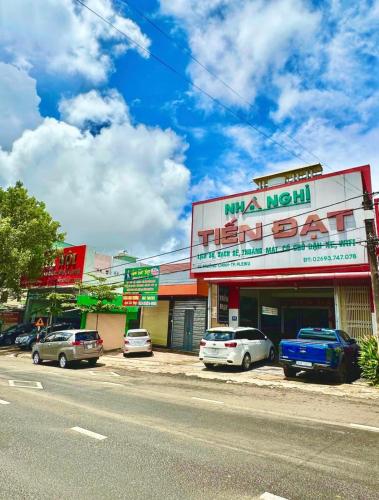 a building with cars parked on the side of a street at Tien Dat Motel in Pleiku