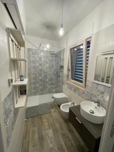 a bathroom with a toilet and a sink at Muschiaturo in Foce Varano